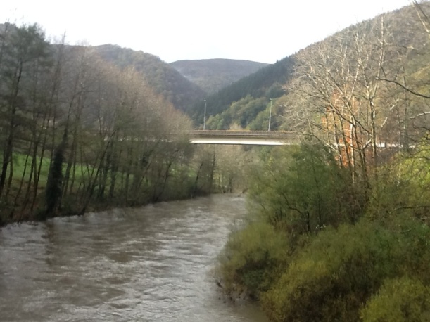 Swollen river, steep sided valley